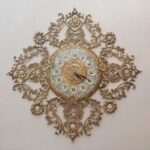 Price and Buy Luxurious Brass Wall Clock Featuring a Delicate Floral Accent