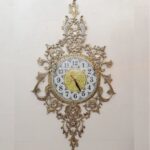 Price and Buy Luxurious Brass Wall Clock Featuring a Delicate Floral Hanging Accent